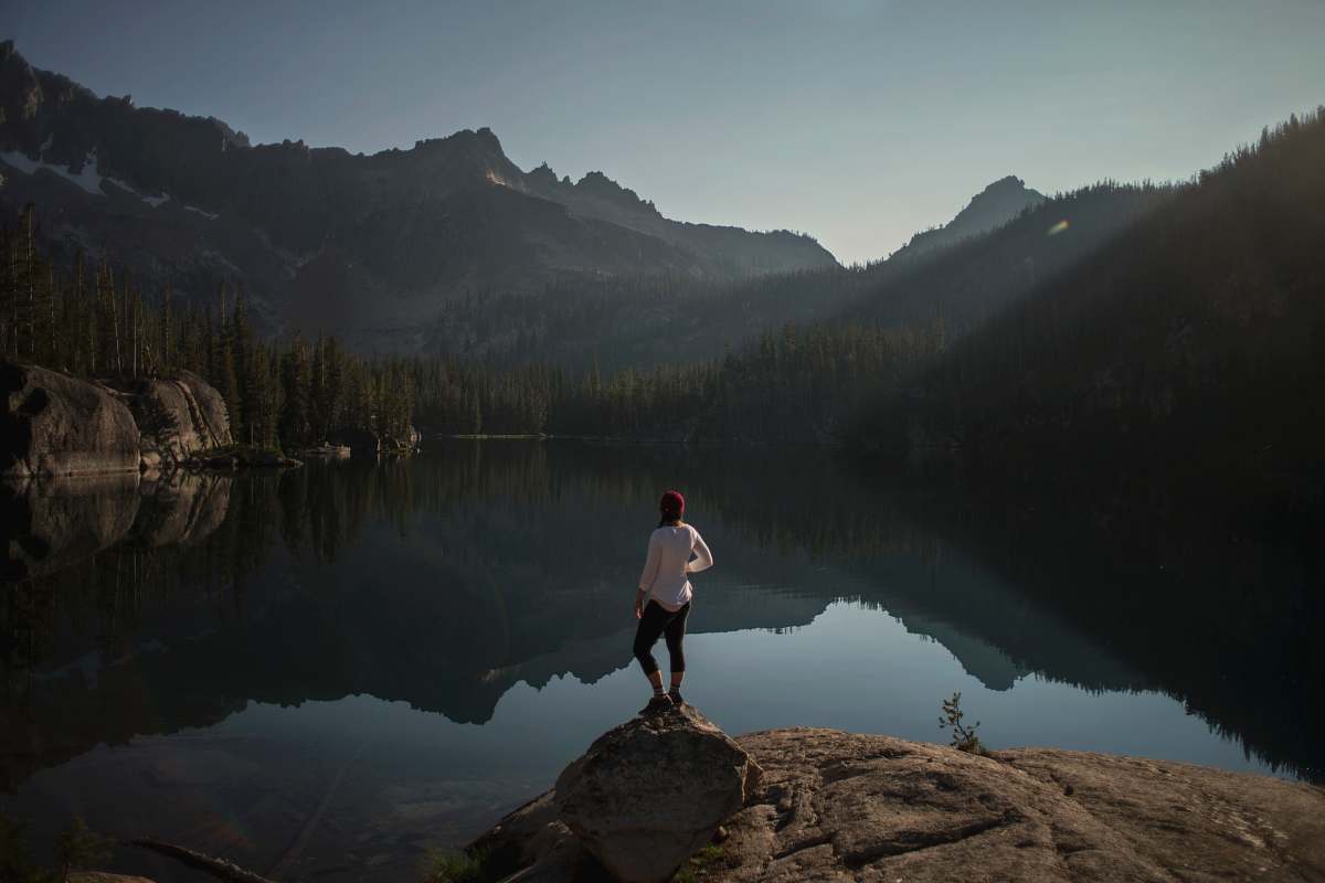 lake person standing on cliff near lake sawtooth range